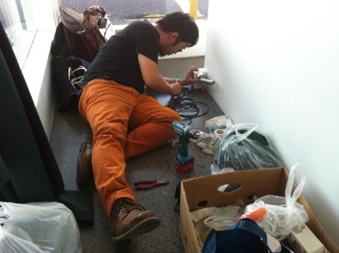 Alvin Xiong installing at Corner; photo courtesy of the artist