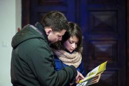 Couple studying the Narracje 5 trail map before setting out; photo by Bogna Kociumbas