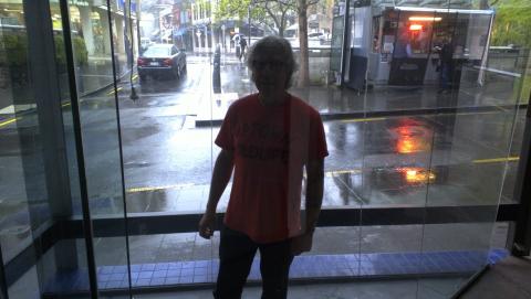 Installation week: Paul Hartigan in the glass window-box preparing to install his new neon work