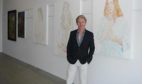 Rob Garrett with Estella Castle paintings exhibited in Garrett & Tongue Pop-Up Exhibition, November 2011, Auckland; photo courtesy of Rob Garrett