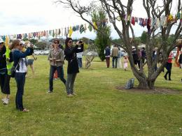 Visitors to NZ Sculpture OnShore enjoying Madpanic Collective's bunting project