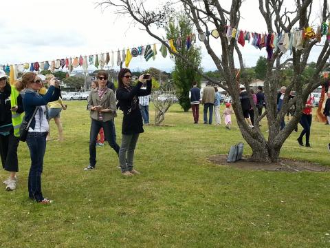 Visitors to NZ Sculpture OnShore enjoying Madpanic Collective's bunting project